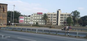 Panoramic view of T John Institute of Technology Bangalore's modern campus, showcasing its buildings, green spaces, and bustling student life.