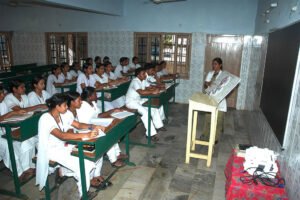 Students at Vijayanagar College of Nursing learning together in a classroom.