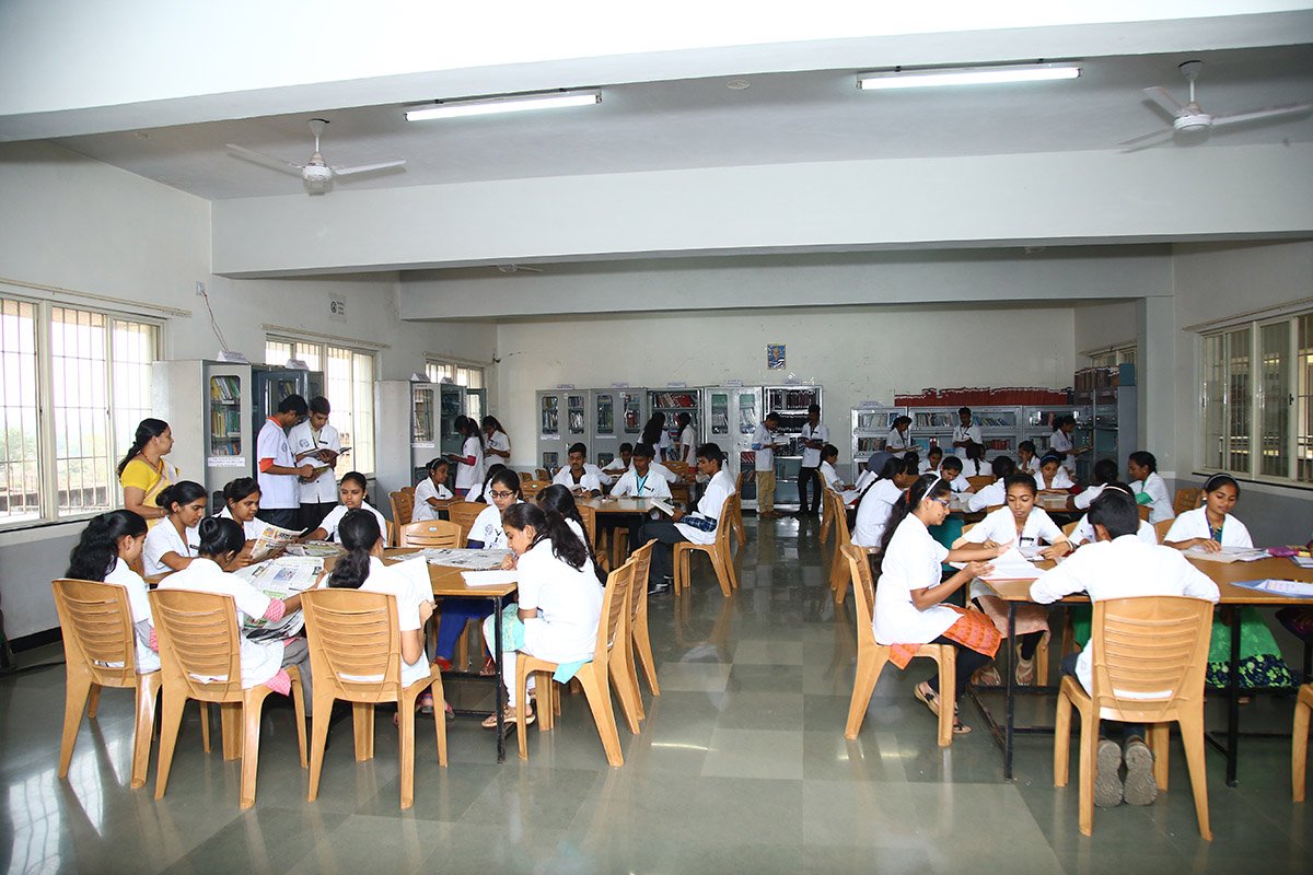 Students in uniform learning at Bharatesh College of Nursing Belgaum, surrounded by modern medical equipment.
