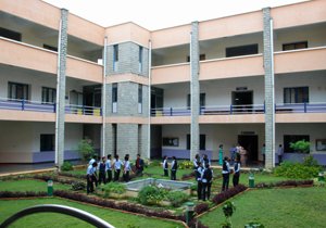 A vibrant and bustling campus scene at Kalpataru Institute of Technology Bangalore, showcasing students engaged in academic pursuits and leisure activities amidst verdant surroundings and modern infrastructure.