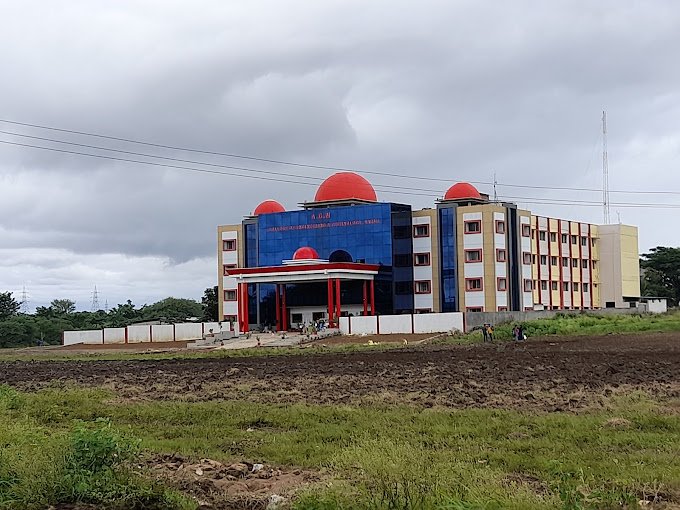 A panoramic view of the AGMR College of Engineering and Technology campus in Hubli, showcasing its modern buildings, library, and sports grounds.